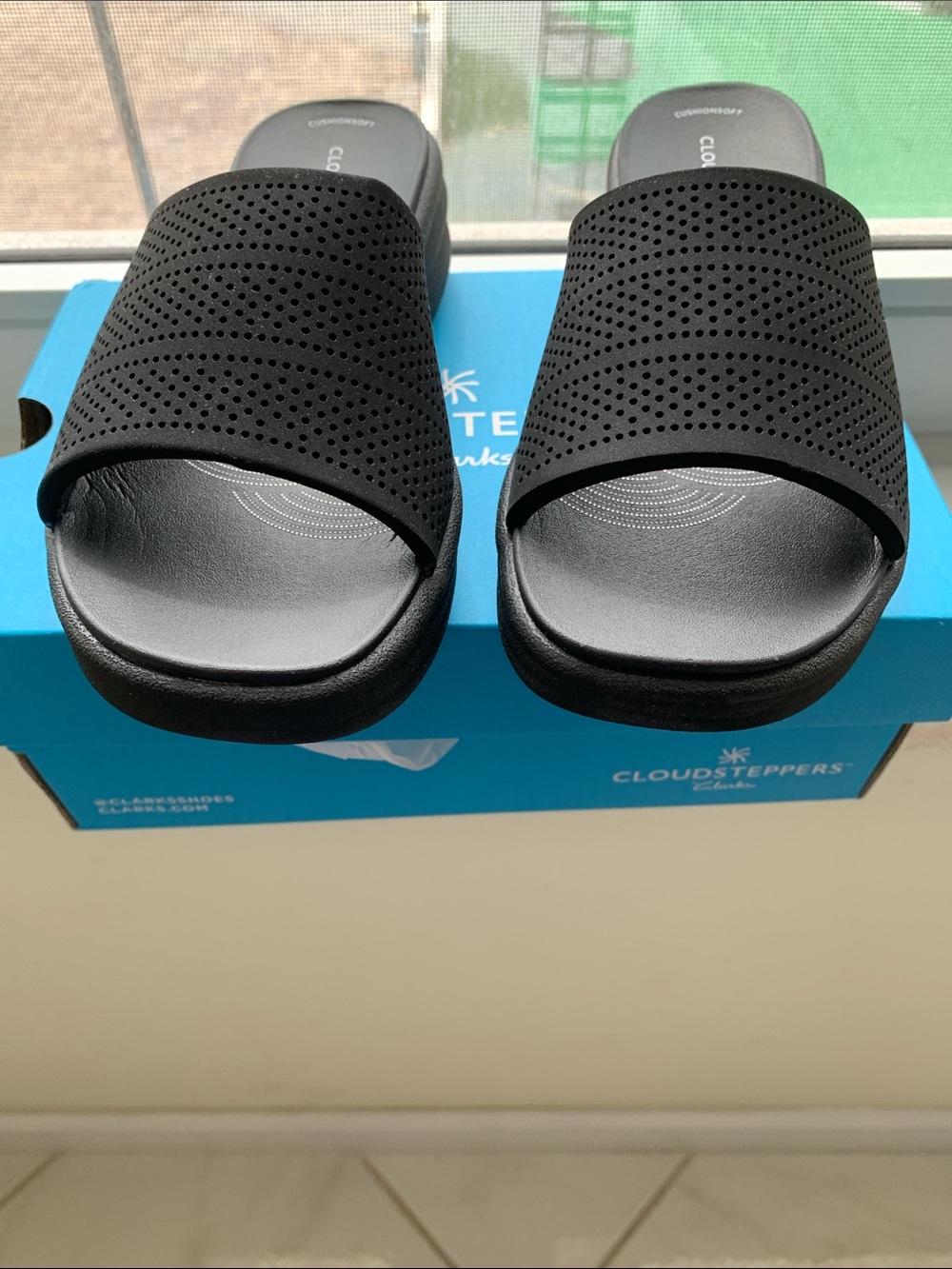 Clarks Black Slip-On Sandals with Wave-Textured Soles
